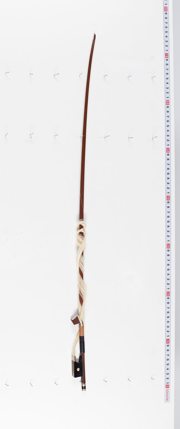 A nickel-mounted violin bow, branded Emile Ouchard