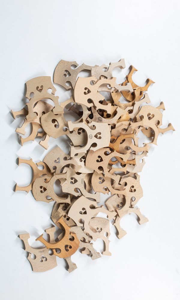 Forty cello bridges, various sizes