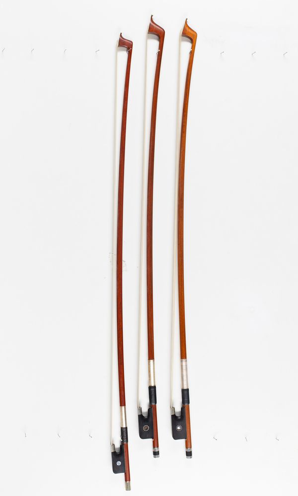 Two cello bows and a violin bow