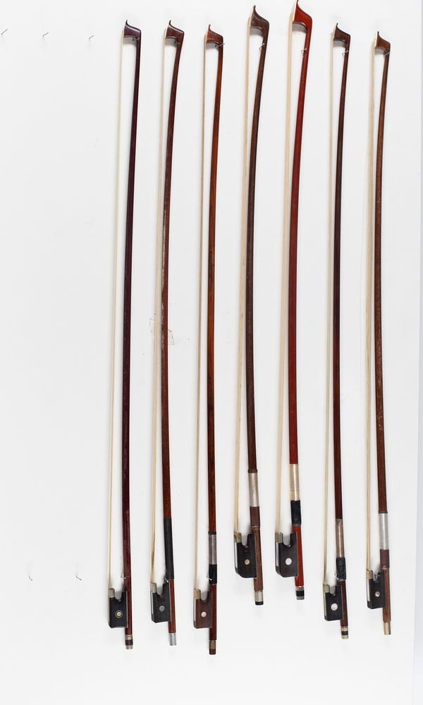 A bundle of five violin bows and two cello bows, varying lengths