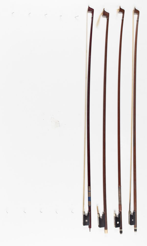 A bundle of four violin bows, varying lengths