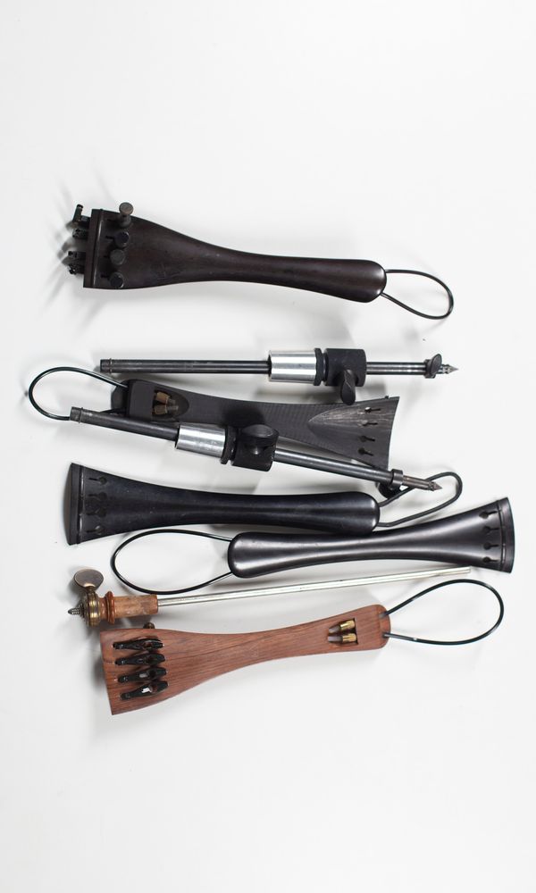 Five cello tailpieces and three spikes