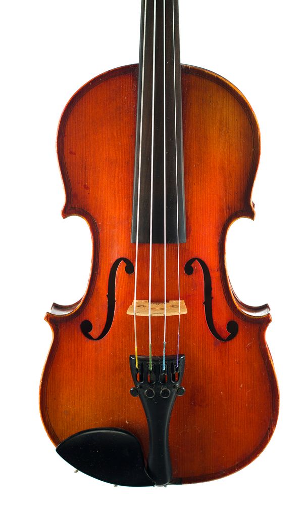 A half-sized violin, labelled Medio Fino