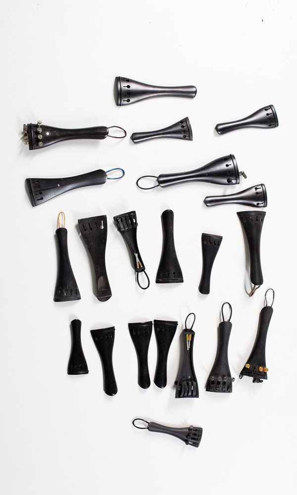 Twenty-one ebony tailpieces, various sizes