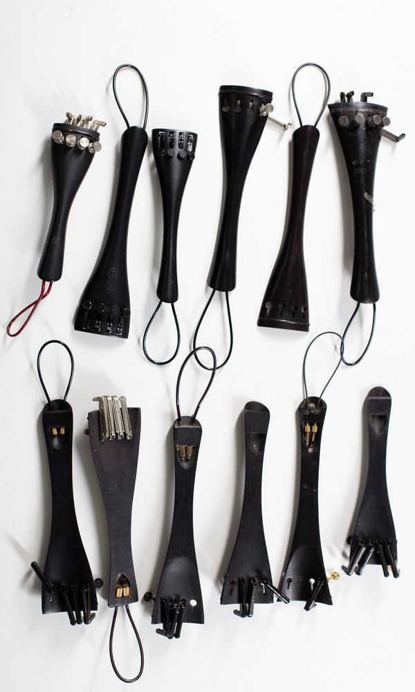 Twenty cello tailpieces, various sizes