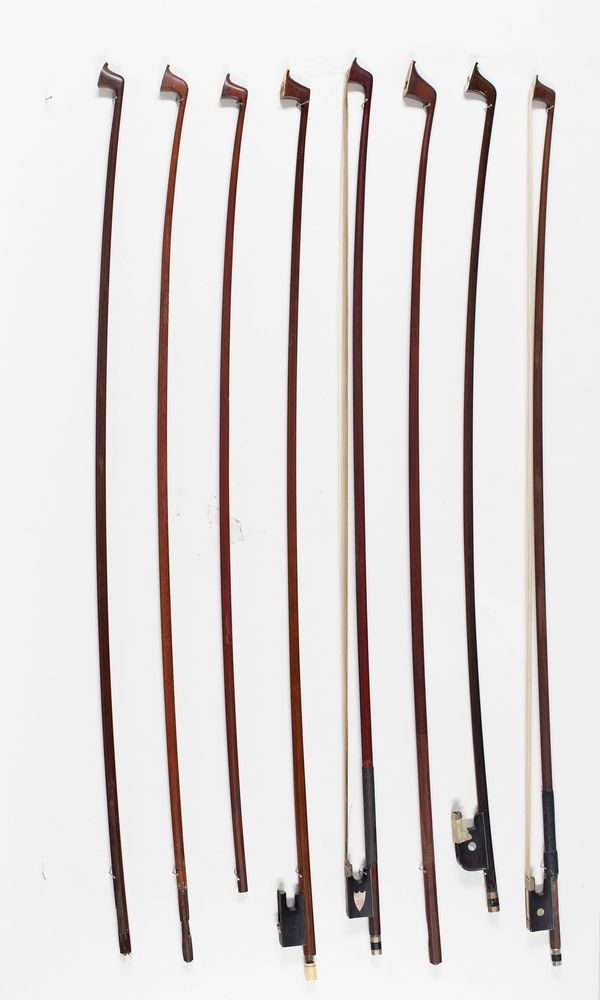 Four violin bows and four bow sticks, varying lengths