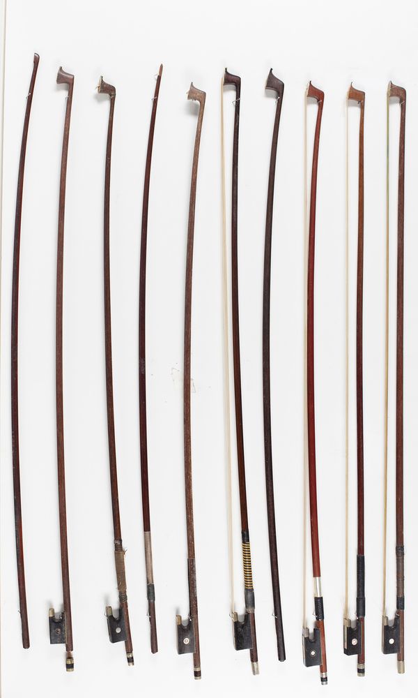 Seven violin bows and three bow sticks, varying lengths