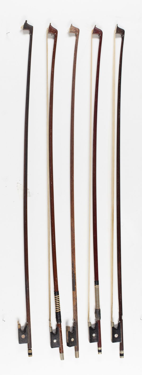 Five violin bows, varying lengths