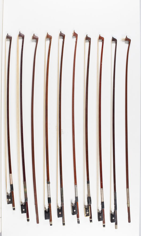 Eight violin bows and two bow sticks, varying lengths