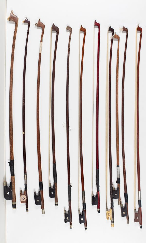 Fifteen violin bows and four bow sticks, varying lengths