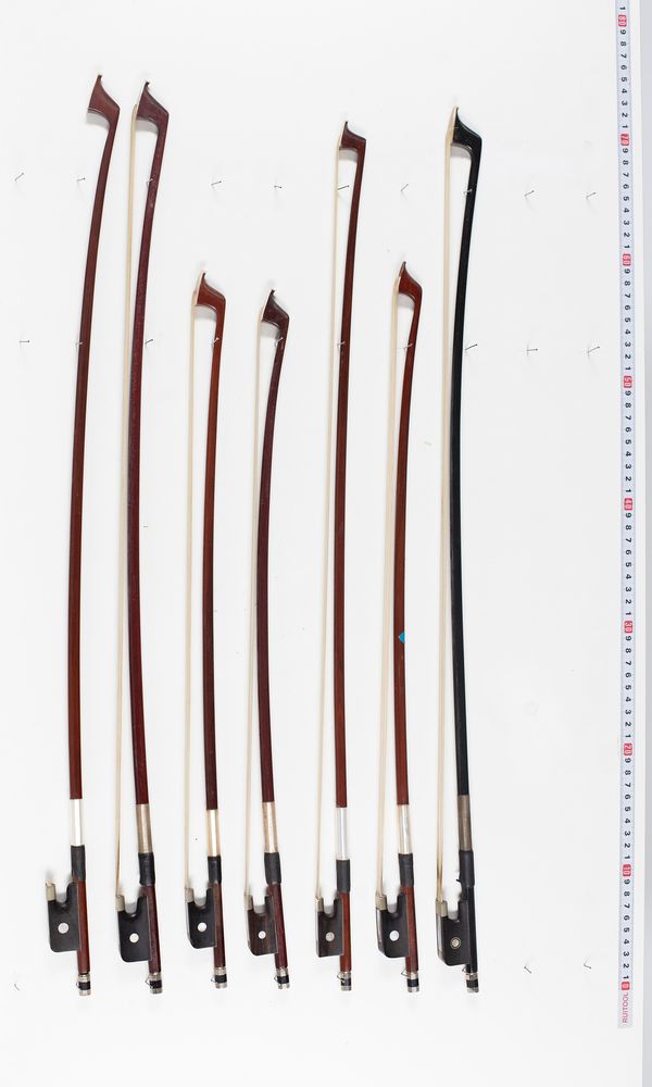 Six cello bows and one violin bow, varying lengths