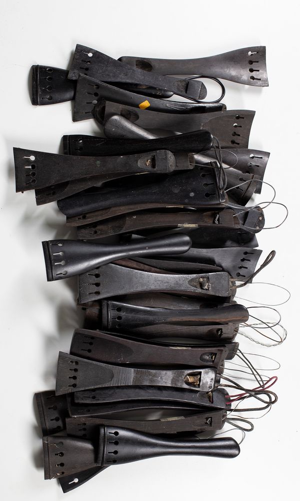 Forty cello tailpieces, varying sizes