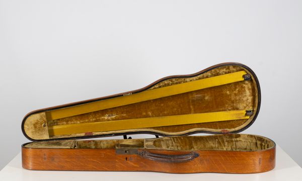 A wooden W. E. Hill & Son violin case