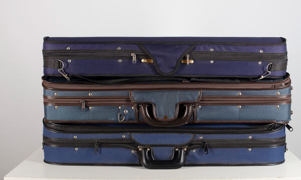 Three blue rectangular violin cases