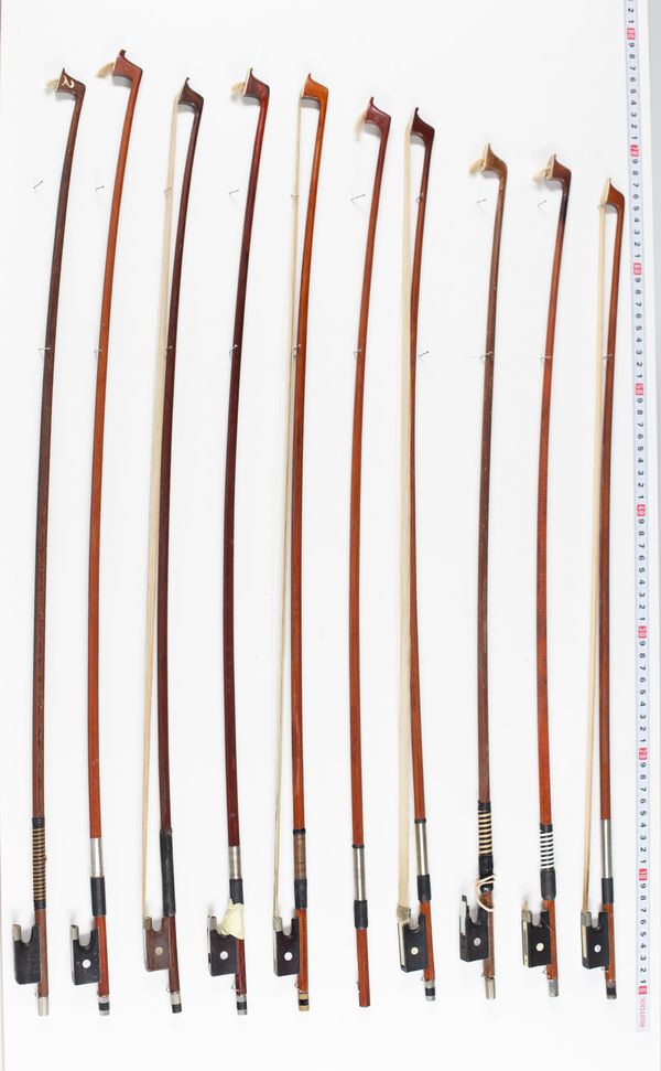 Nine violin bows and one bow stick, varying lengths