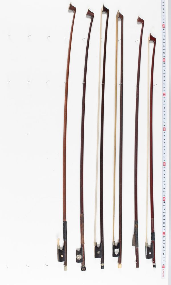 Five violin bows and one bow stick, varying lengths