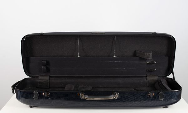 A violin case, branded Hima