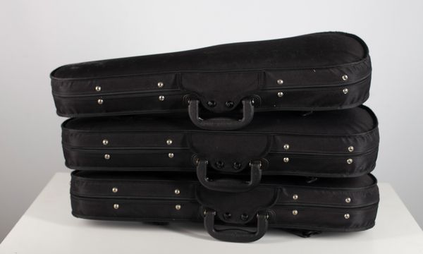 Three black half-size violin cases