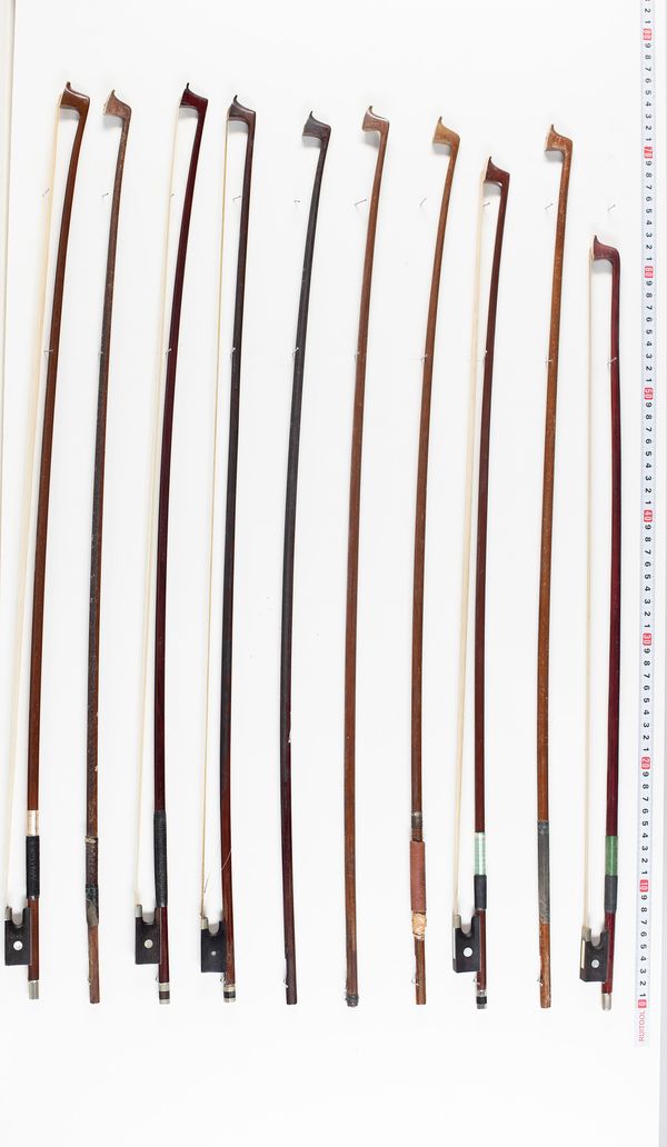 Five violin bows and five bow sticks, varying lengths