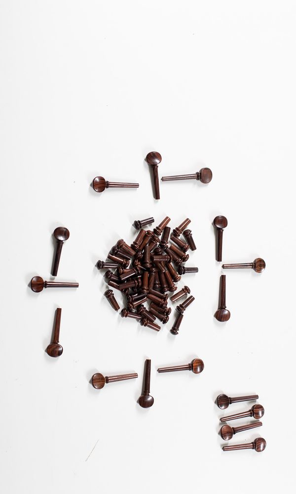 Fifteen sets of four violin Swiss-style pegs and forty-eight end pins, rosewood