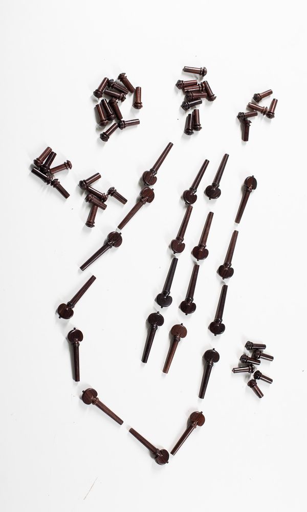 Fourteen sets of four violin heart-style pegs and thirty-nine end pins, rosewood