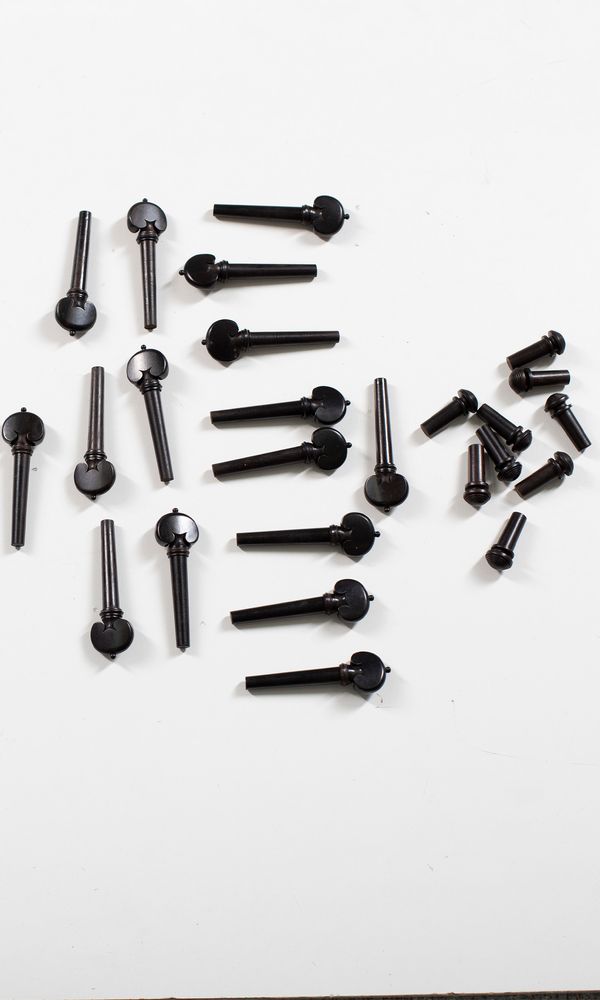 Four sets of four violin heart-style pegs and nine endpins, ebony