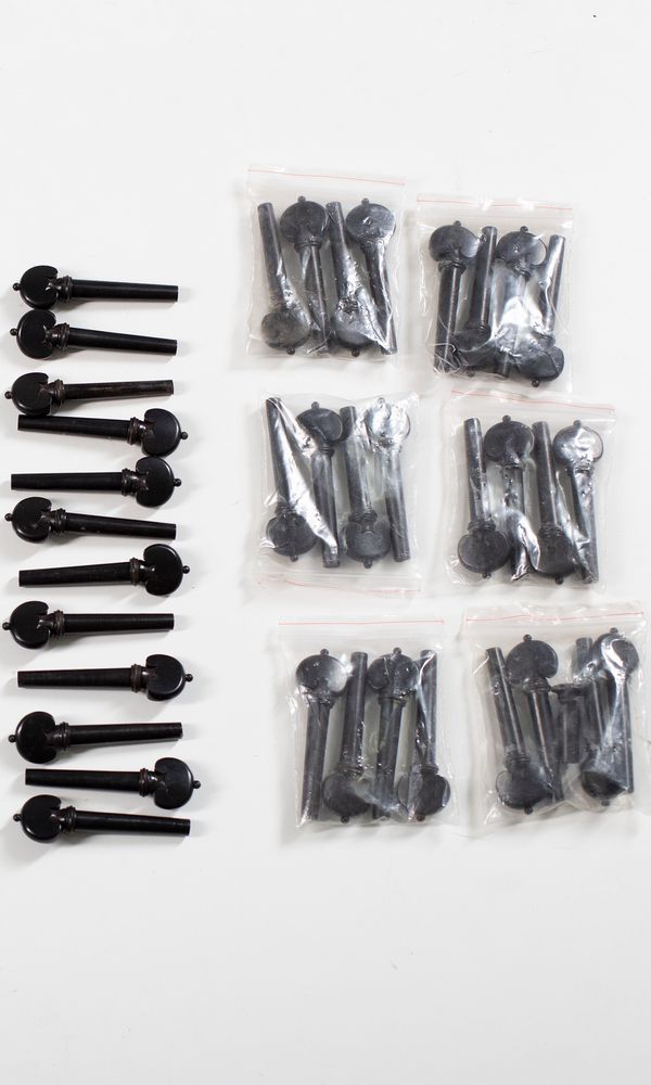 Nine sets of four viola heart-style pegs, ebony