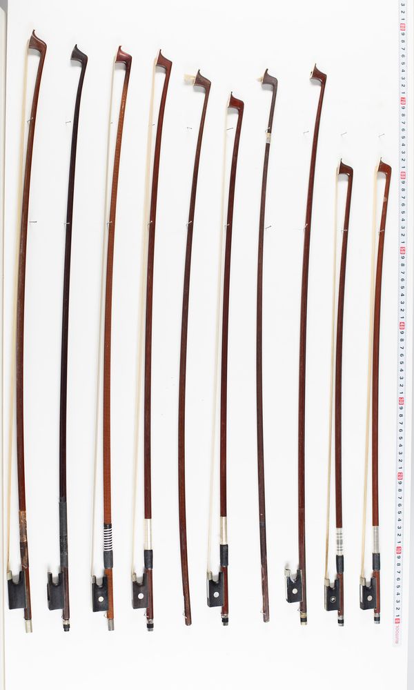 Seventeen violin bows and three violin sticks, varying lengths