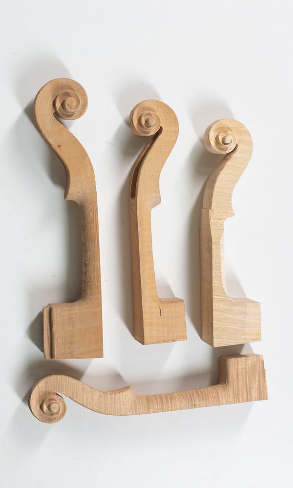 Four partially made violin scrolls