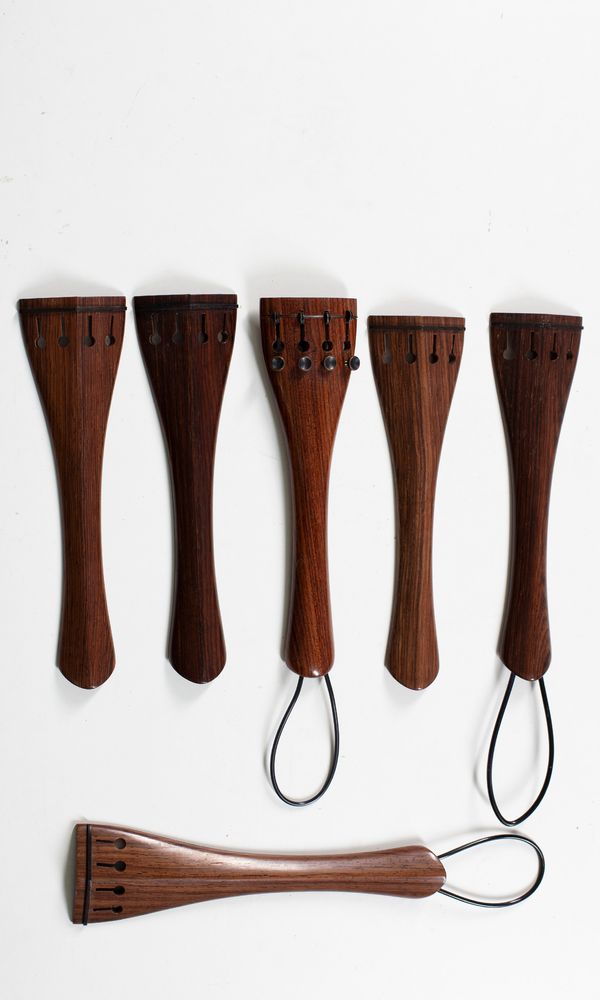 Six rosewood cello tailpieces