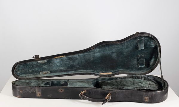 A violin case, branded W. E. Hill & Sons