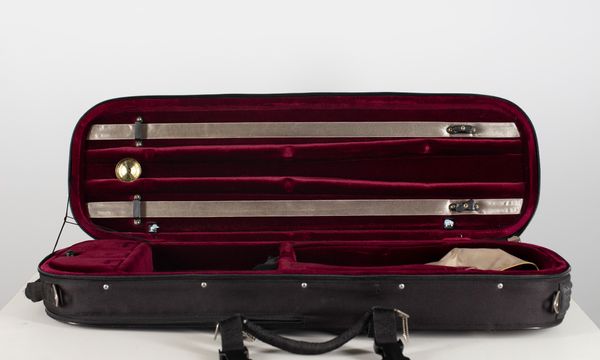 A violin case, branded Artomus