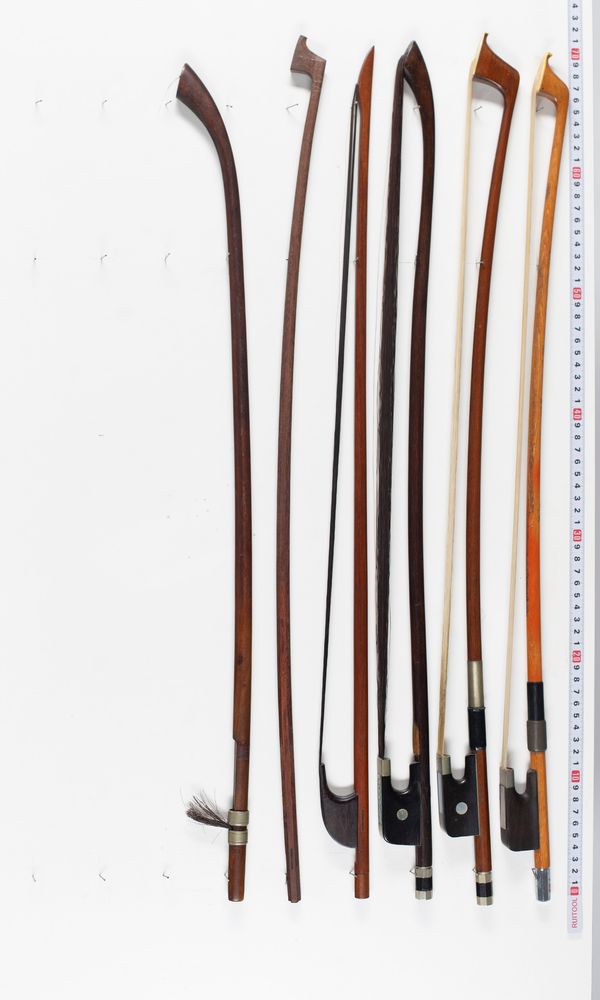 Five double bass bows and and one baroque bass bow, varying lengths