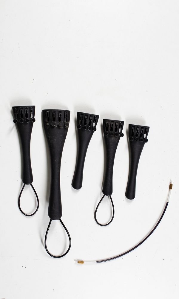 Five cello tailpieces and eleven tail adjusters