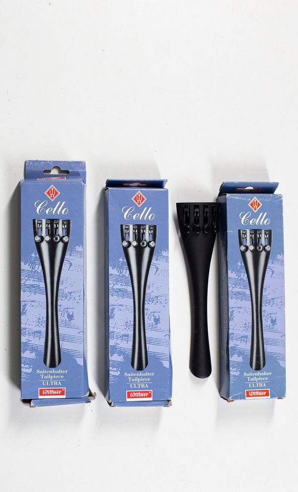 Four cello tailpieces branded Saitenhalter