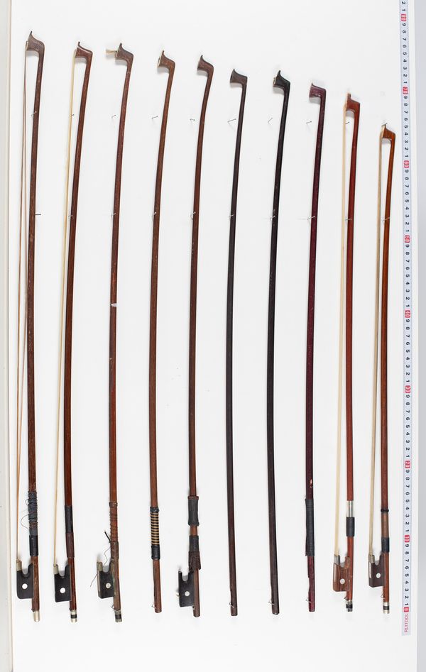 Seven violin bows and four violin sticks, varying lengths