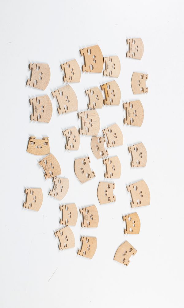 Eight viola and twenty two violin bridges, varying sizes