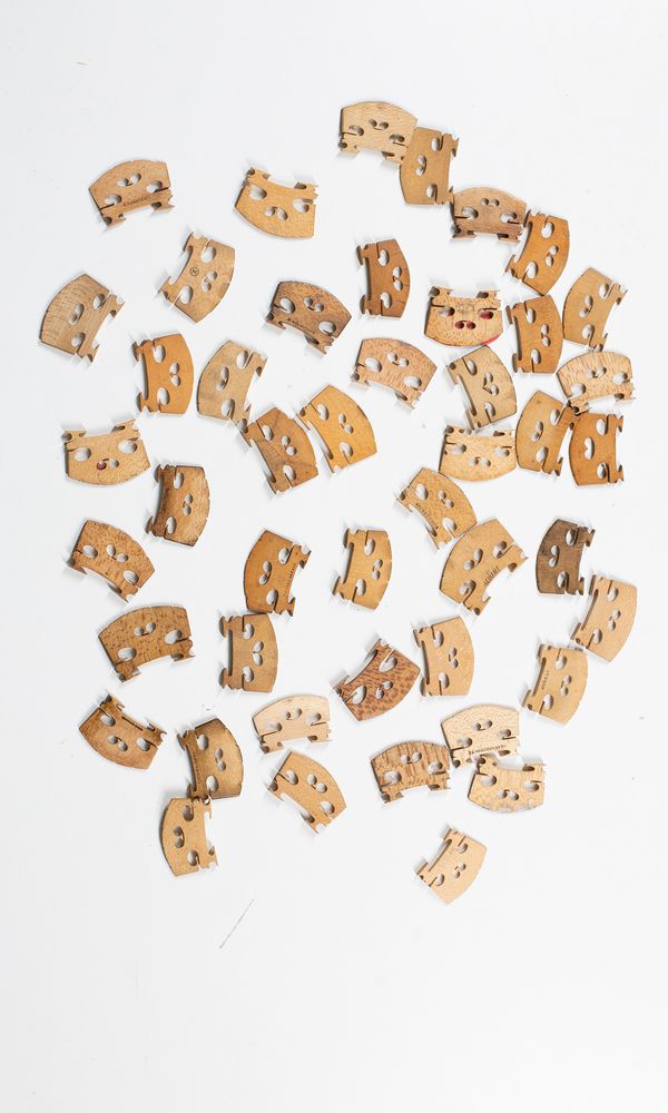Forty six violin bridges, varying sizes