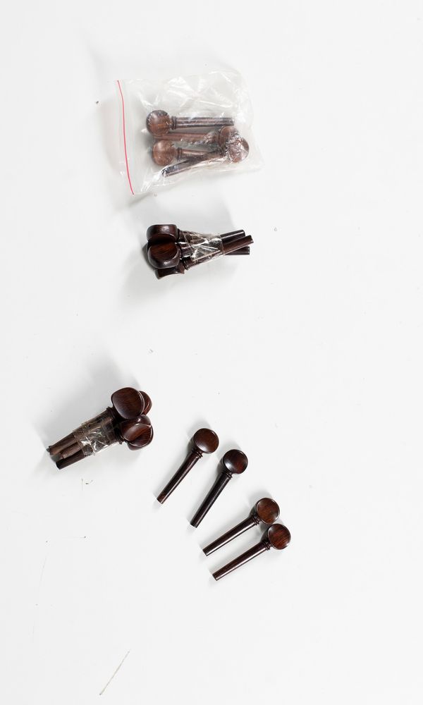 Four sets of violin pegs, varying sizes