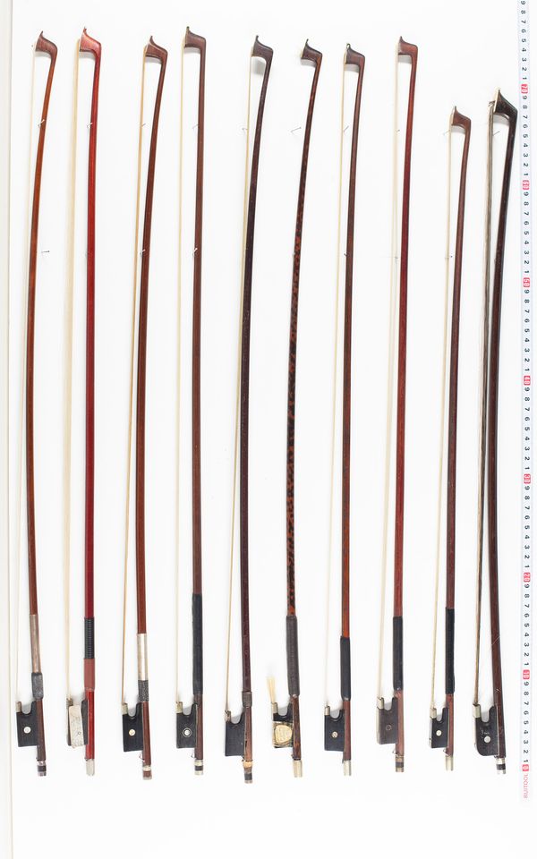 Fifteen violin bows and three cello bows, various lengths