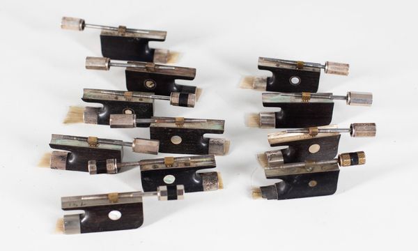 Ten silver-mounted cello frogs and one nickel-mounted cello frog