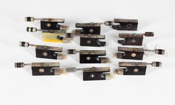 Eight silver-mounted violin frogs and four nickel-mounted violin frogs