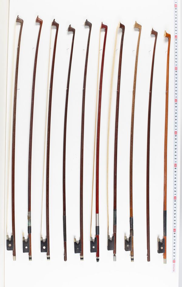 Thirteen violin bows and two violin sticks, varying lengths