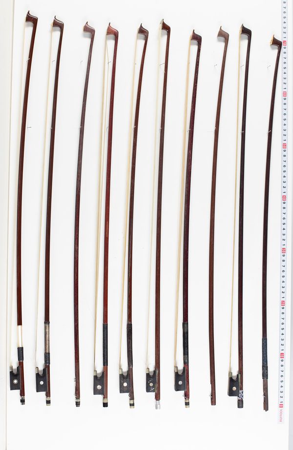 Fourteen violin bows and two violin sticks, varying lengths