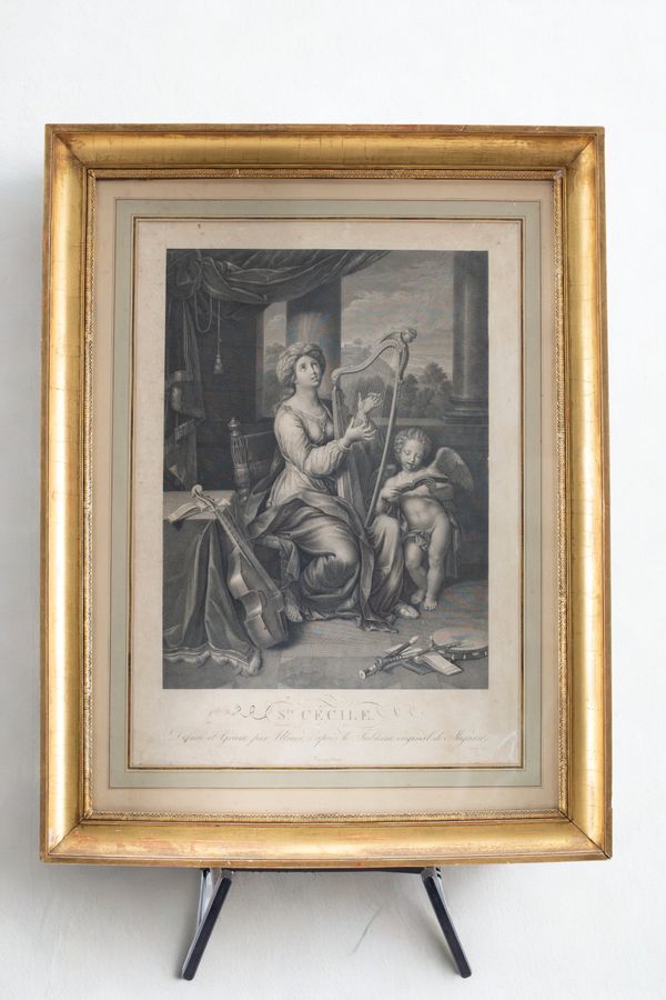 A framed print of St Cecilia playing the harp