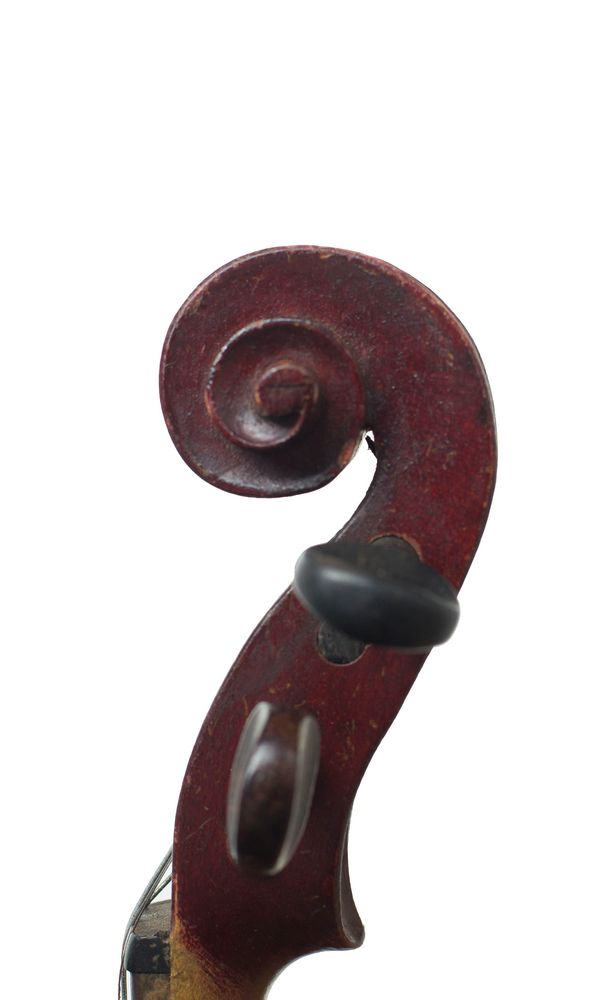 A child's violin labelled Medio Fino - scroll