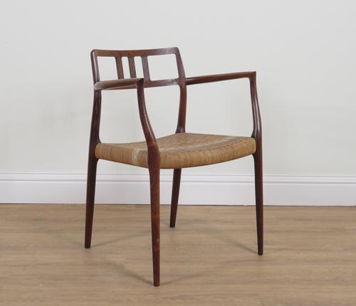 NIEL OTTO MOLLER FOUR J L MOLLER; A MID 20TH CENTURY WOVEN LEATHER SEATED ROSEWOOD OPEN ARMCHAIR