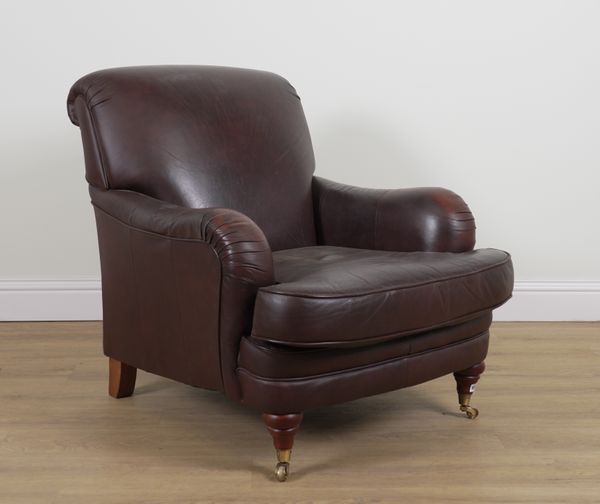 A BROWN LEATHER EASY ARMCHAIR