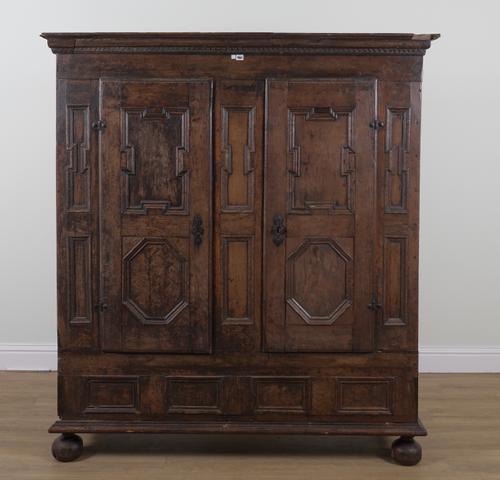 A 17TH CENTURY AND LATER OAK HANGING CUPBOARD