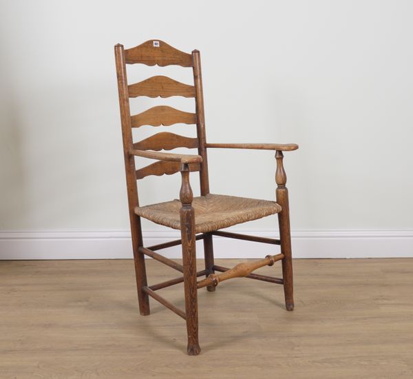 AN EARLY 19TH CENTURY RUSH SEATED ASH LADDER BACK OPEN ARMCHAIR